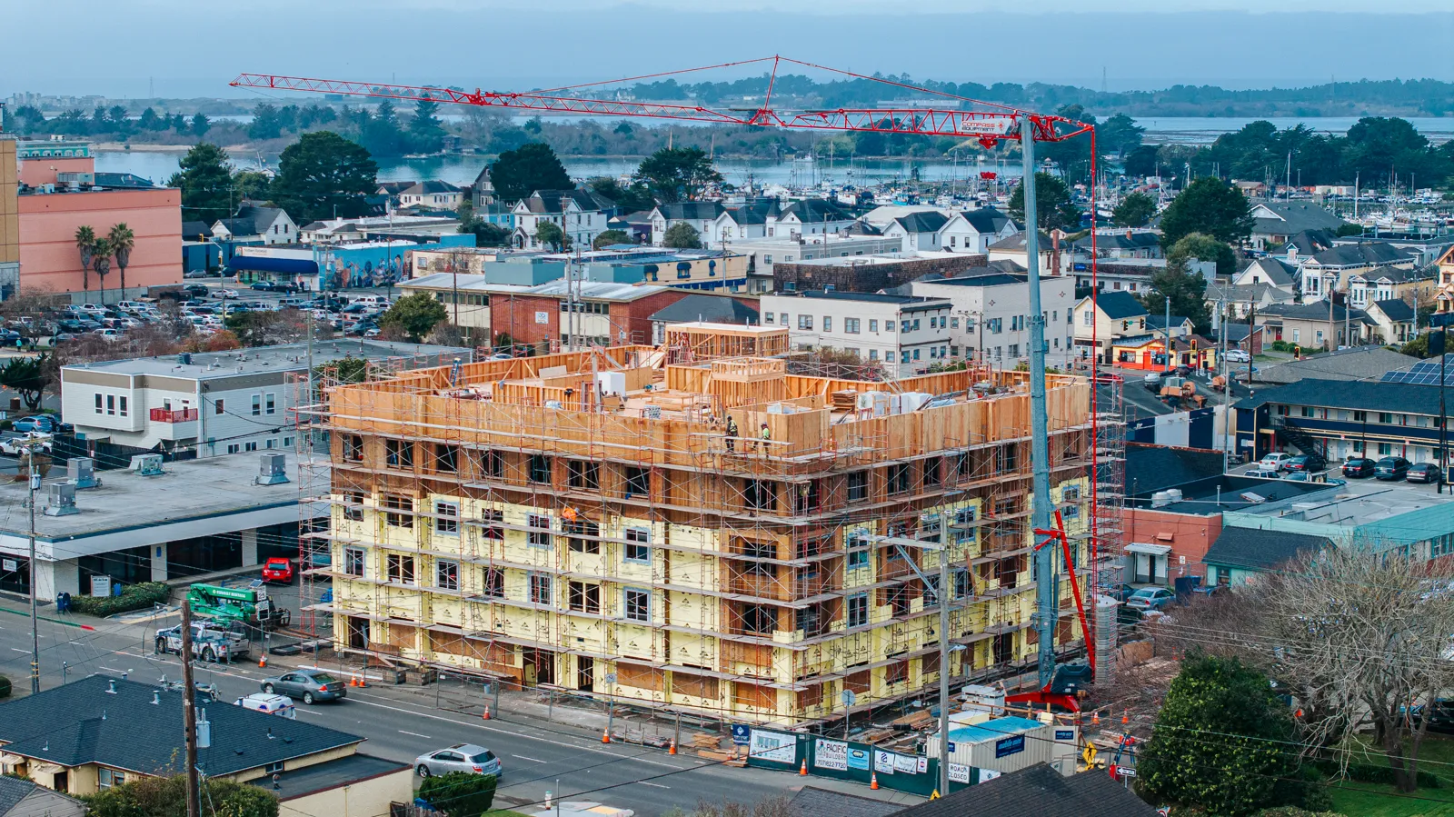 Five-story wood-frame construction site documented from the air