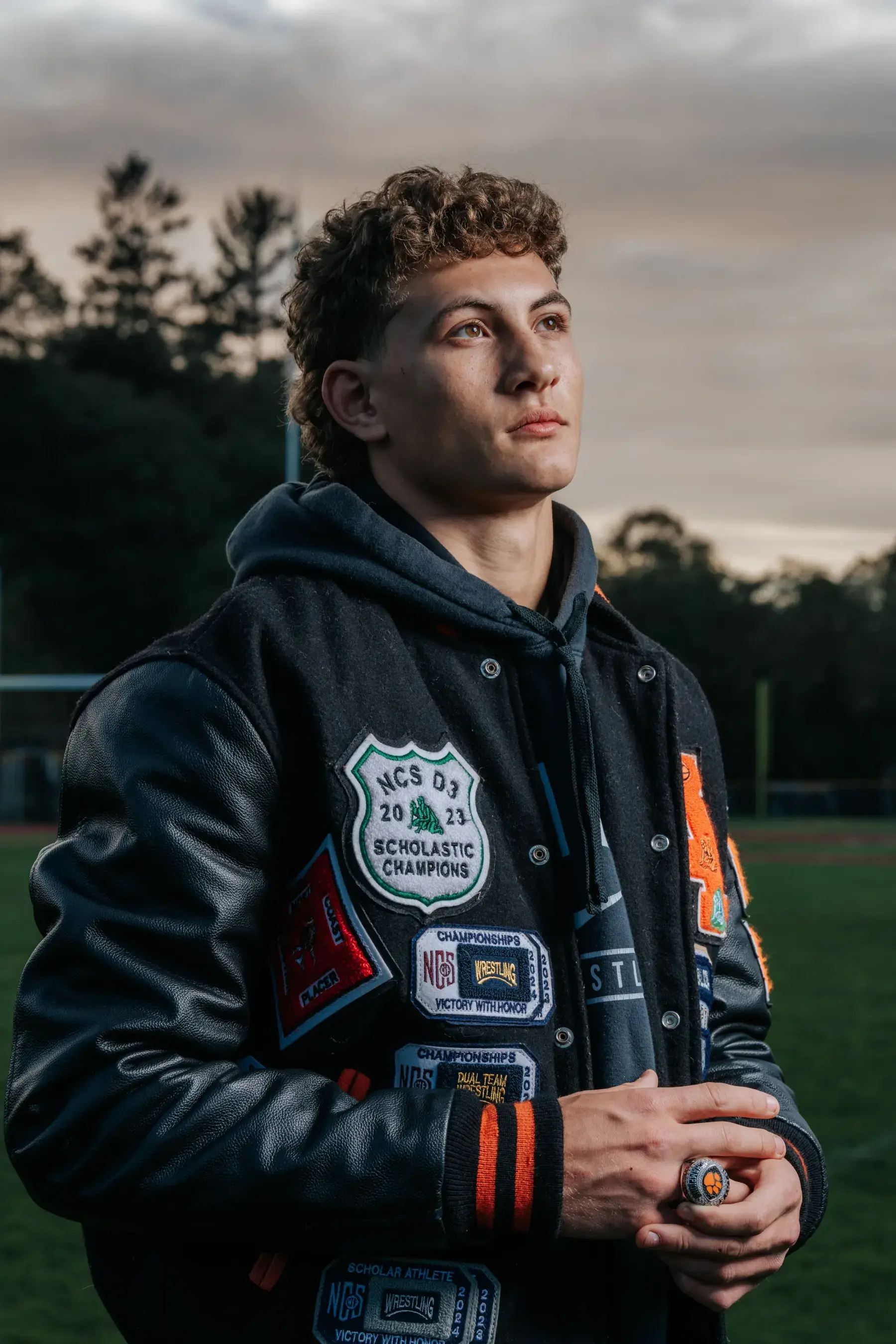 Athletic senior portrait under stadium lights by Tex Kelly Productions