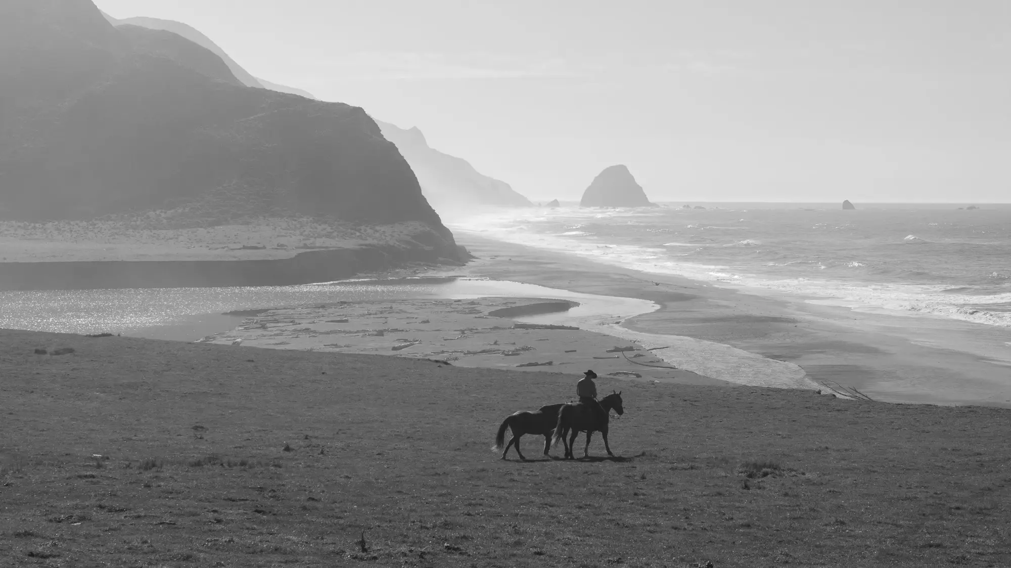 Aerial drone shot of a senior on horseback along the coast, Tex Kelly Productions