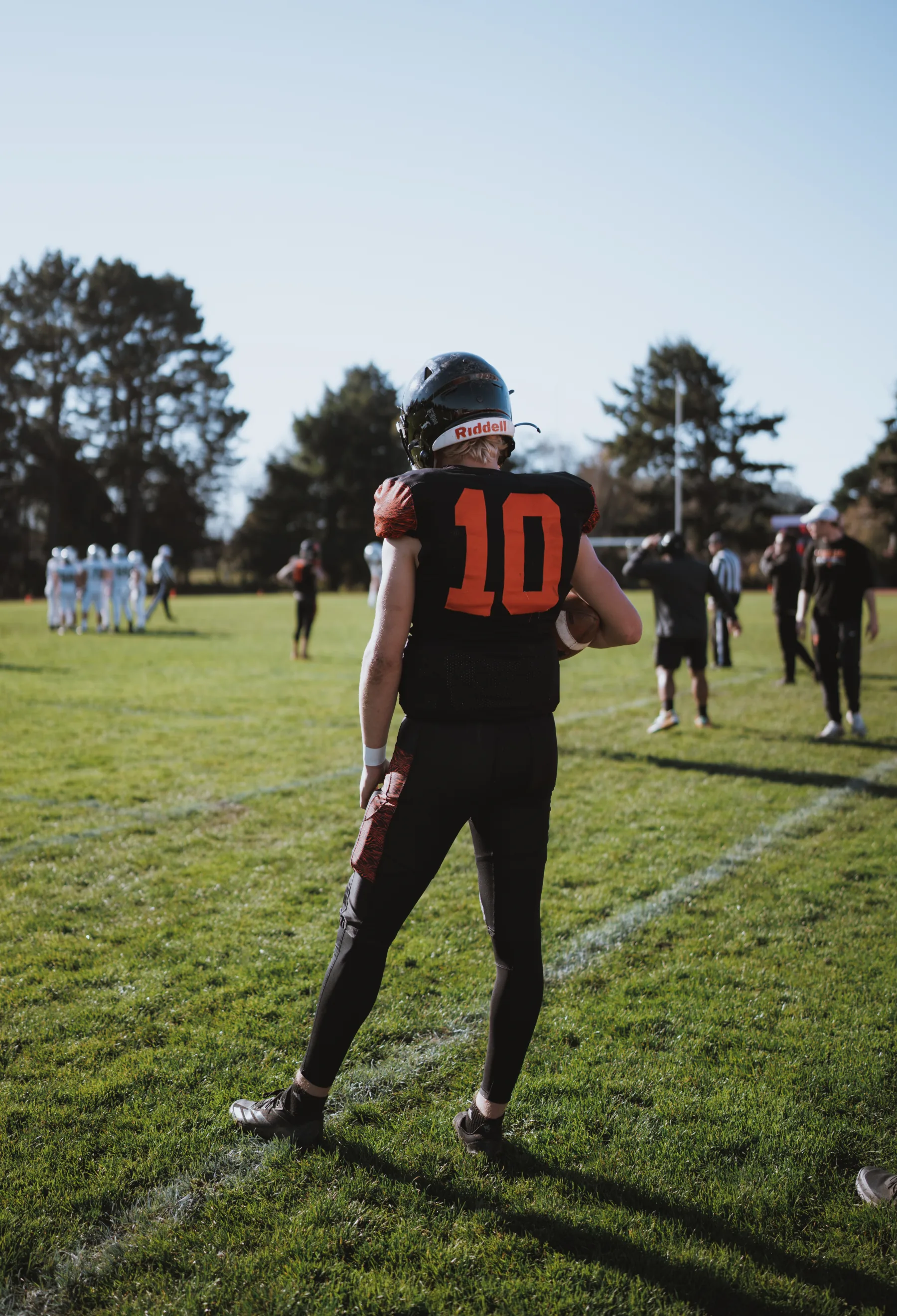 Arcata High quarterback, jersey 10, on the field before the section championship