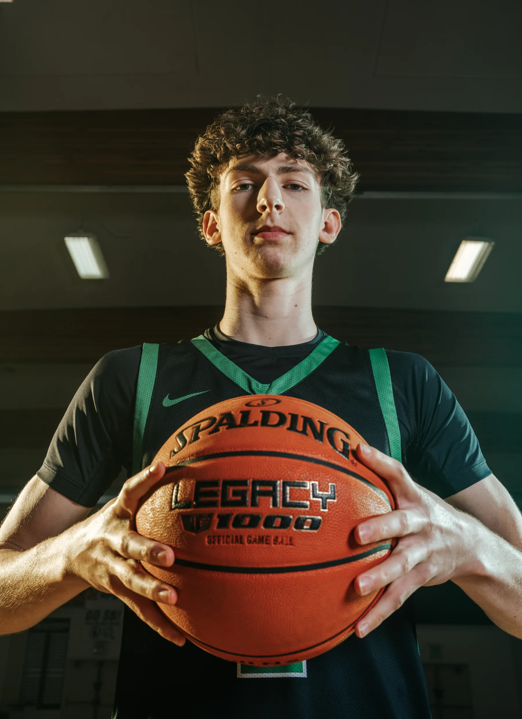 Game ball held up to the lens, dramatic overhead flash portrait